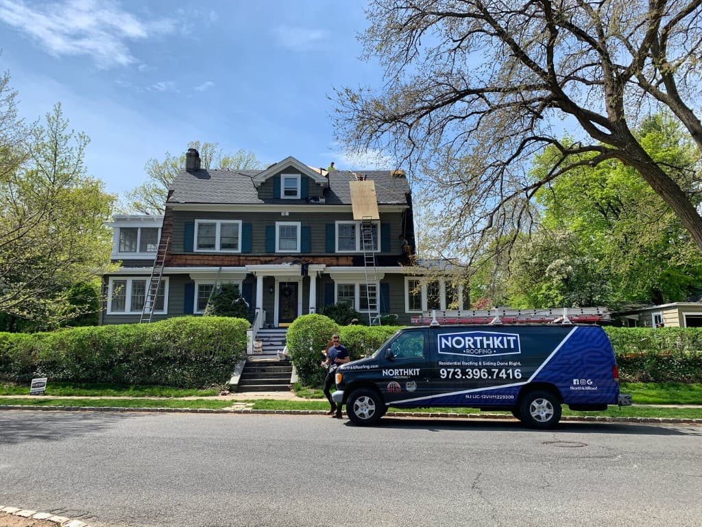Northkit crew replacing shingles on a residential roof